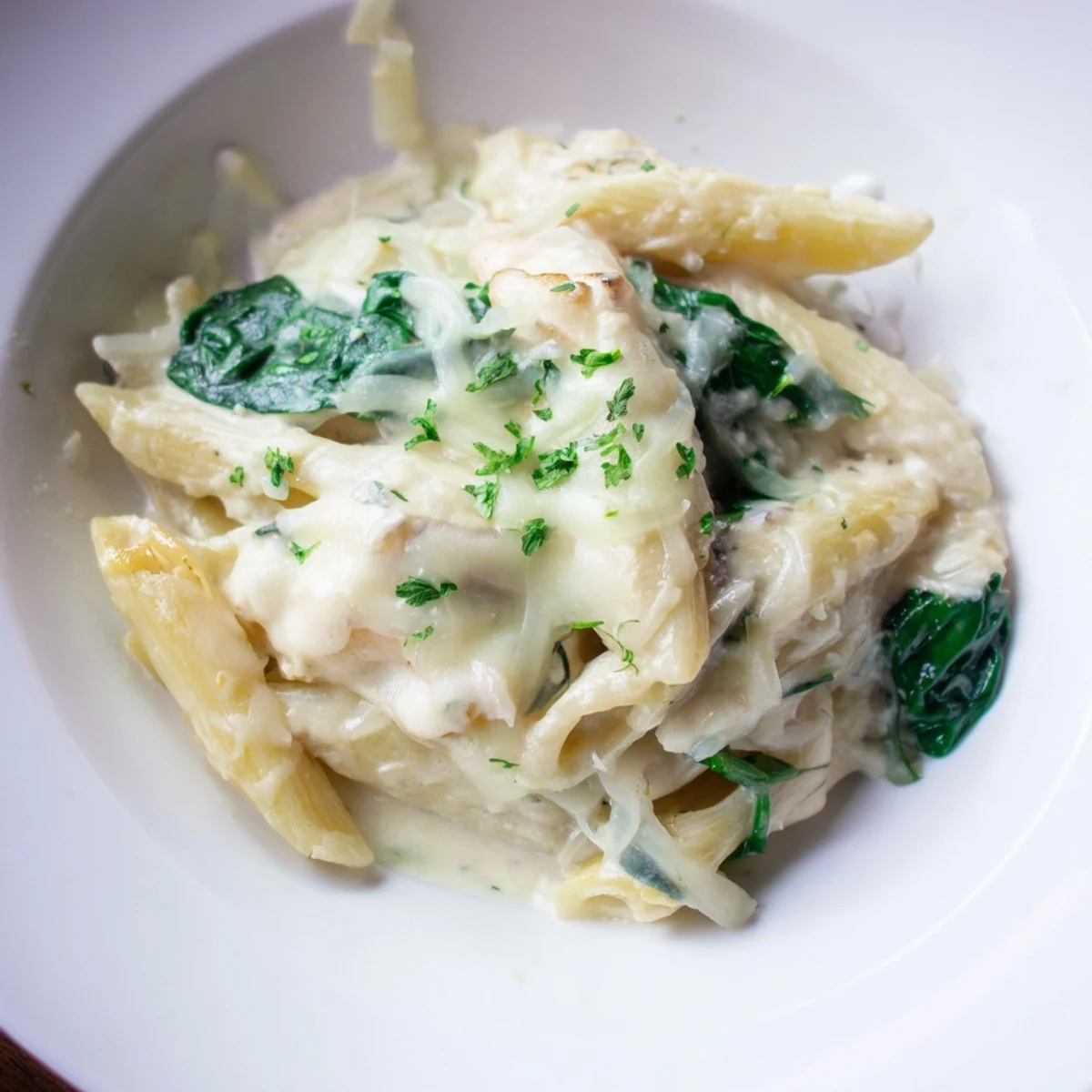 The Magic Casserole: Creamy Spinach Pasta, with bubbly cheese and tender pasta in a skillet.