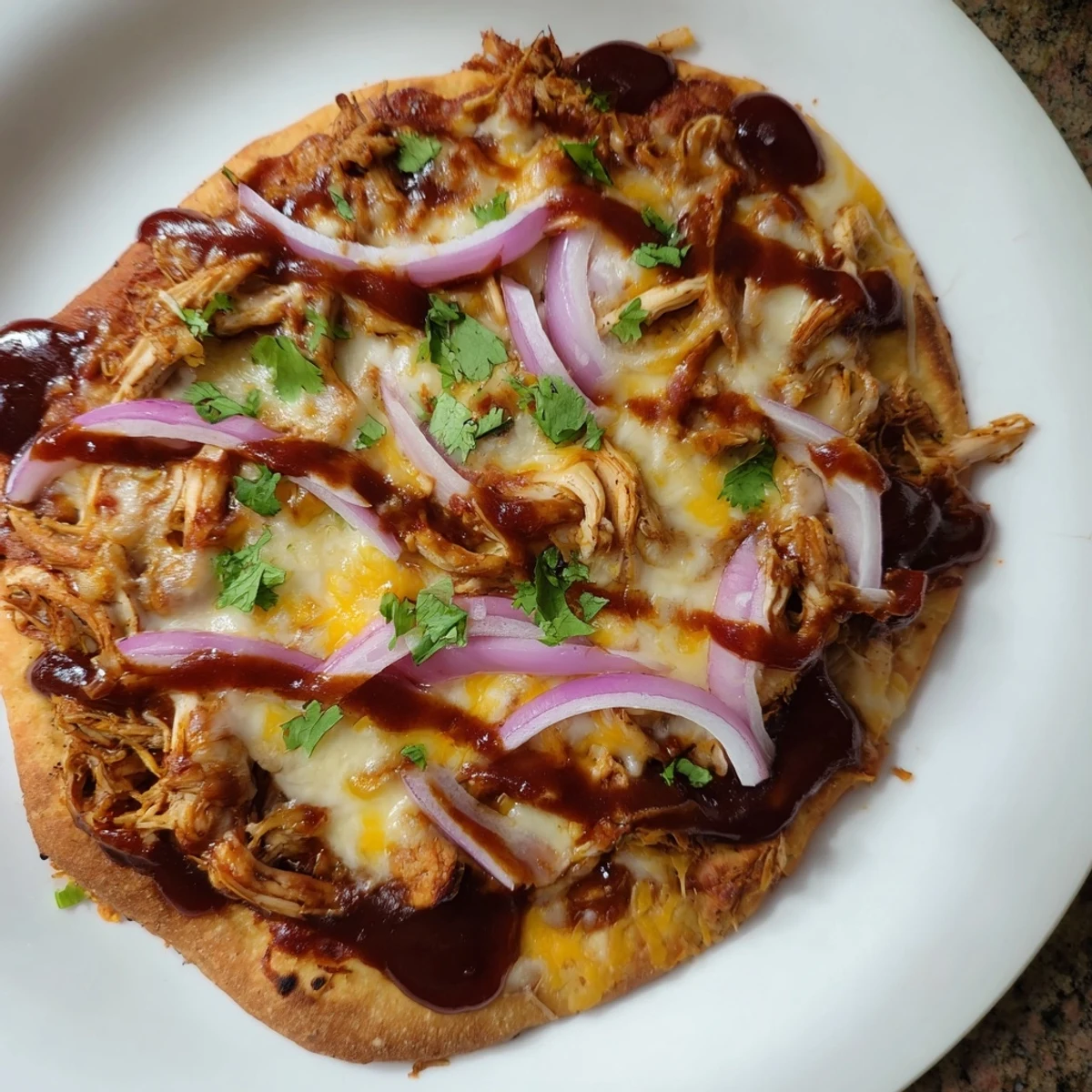 Golden, bubbly BBQ Chicken Flatbread with melty cheese and fresh cilantro, a delicious meal.