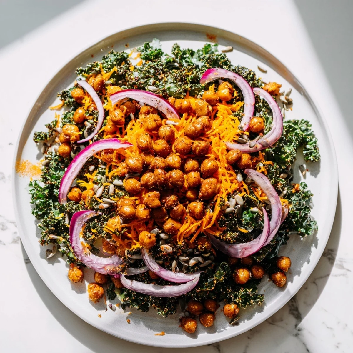 A healthy and colorful Kale Salad with Roasted Chickpeas, ready for a light and tasty meal.