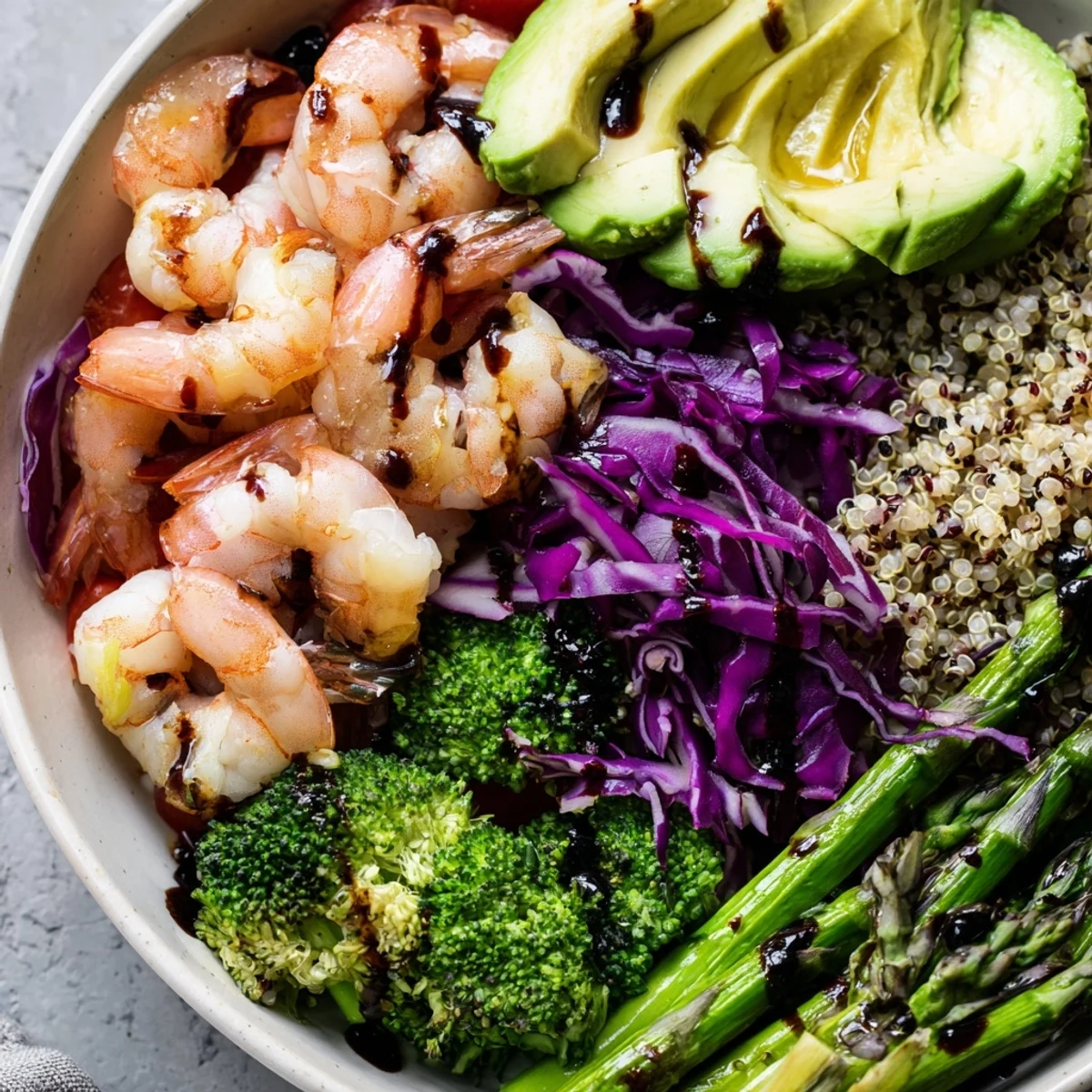 A vibrant Detox Buddha Bowl with Shrimp and Quinoa, featuring roasted broccoli, asparagus, and creamy avocado on a fluffy quinoa base.  