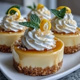 Lemon mousse cups with shortbread cookies, garnished with mint and lemon zest curls, perfect for spring gatherings.  