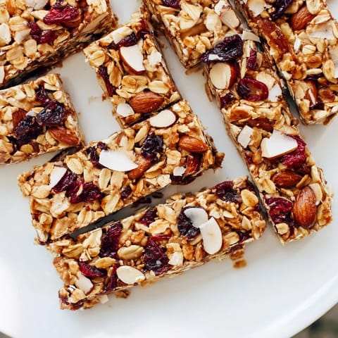 A close-up of delicious No-Bake Energy Bars, studded with nuts and dried fruit, ready to enjoy.