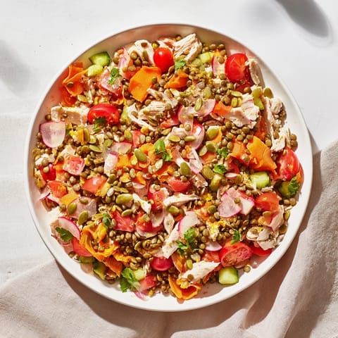 This Chicken and Lentil Recession Salad showcases tender chicken, hearty lentils, vibrant tomatoes, and a bright lemon dressing.