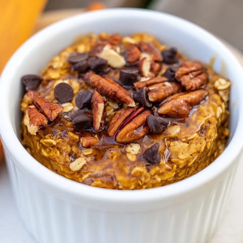 A close-up of fluffy pumpkin spice baked oats, warm and inviting straight from the oven.