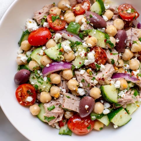 This Tuna Chickpea Salad shows a bright medley of ingredients ready for a healthy meal.