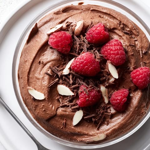 Decadent chocolate avocado mousse with a sprinkle of shaved dark chocolate, ready to enjoy.