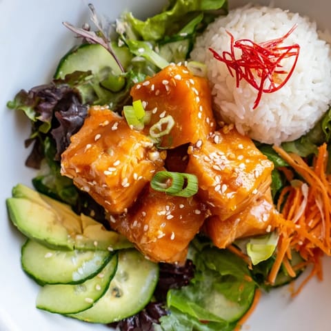 Enjoy a refreshing Poke Bowl Salad, featuring marinated fish, creamy avocado, crisp greens, served immediately.