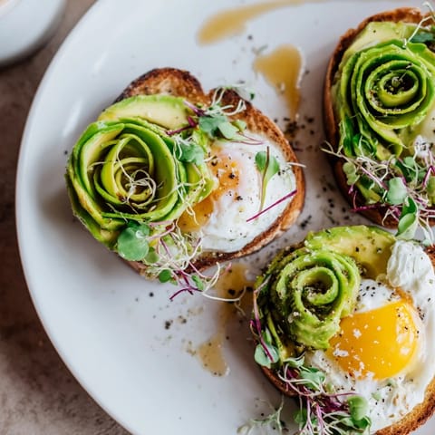 Golden baked Cloud Toast 2.0 with a runny yolk center, avocado, and drizzled honey—a gourmet morning meal.