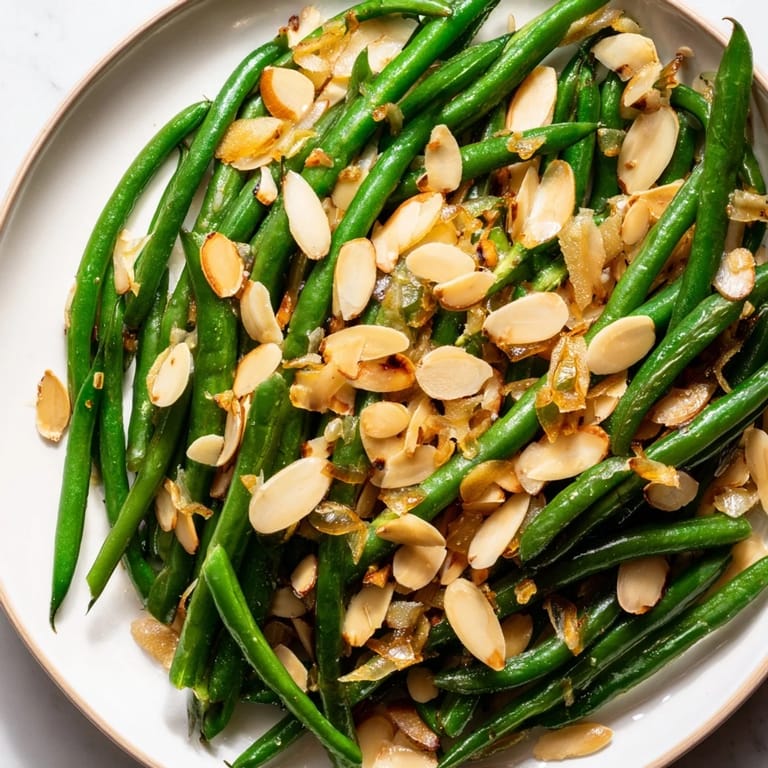 Fresh Sautéed Green Beans with Garlic and Almonds, a quick, simple side ready in minutes.