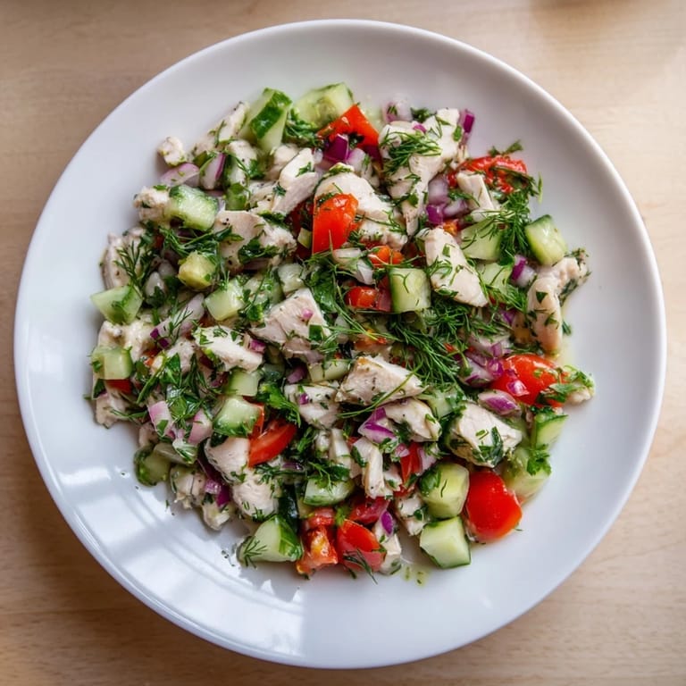 A bright bowl of refreshing Cucumber and Chicken Clean Shaker salad, perfect for a light, delicious meal.