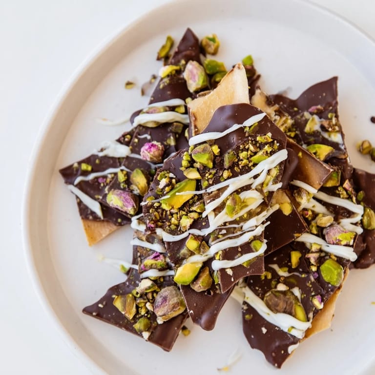 This homemade Pistachio Dubai Chocolate Bark features a beautiful swirl of white chocolate drizzle and rose petals.