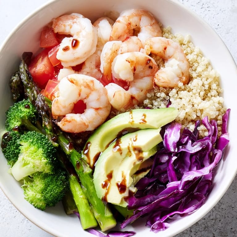 Healthy Detox Buddha Bowl with Shrimp and Quinoa, showcasing crisp red cabbage, diced tomato, and herbs on a nourishing grain base.