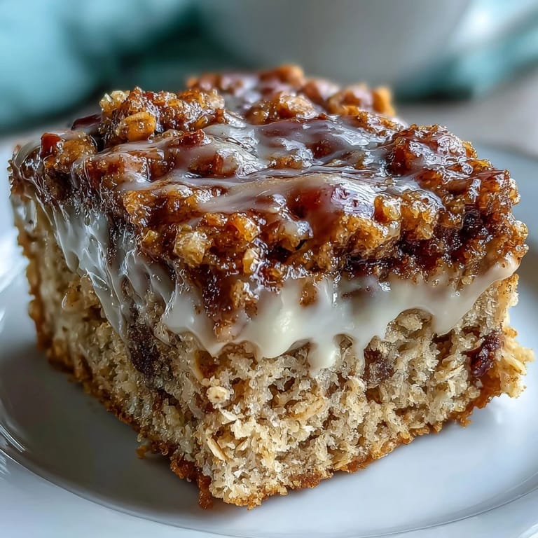 A single slice of baked High-Protein Cinnamon Swirl Coffee Cake Oats served on a plate, showcasing its moist, fluffy texture and rich cinnamon filling.