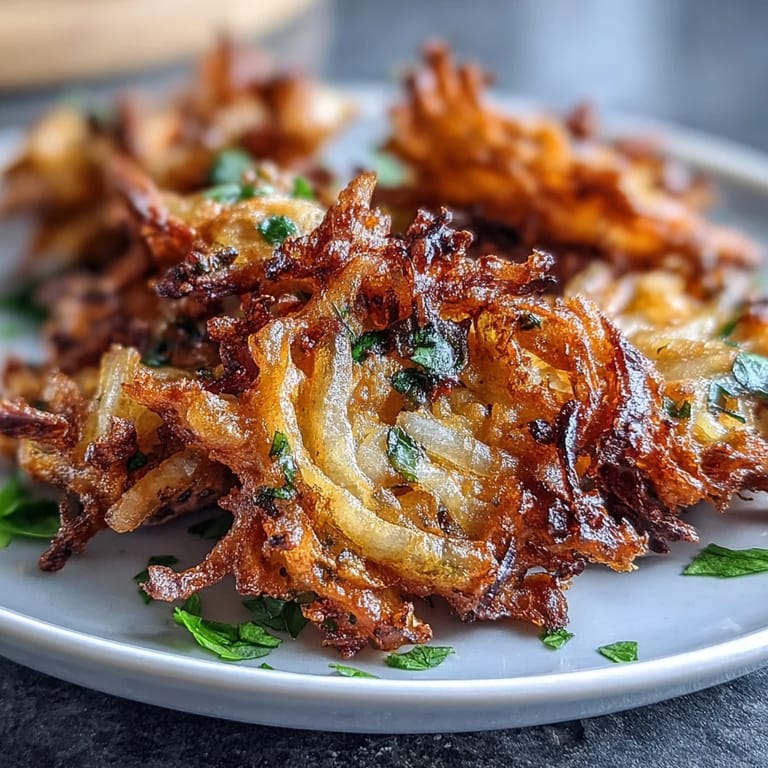 Spicy vegan onion fritters made in the air fryer, featuring gram flour and turmeric for authentic Indian flavor.  