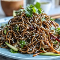 Vibrant cold soba noodle salad with sesame ginger dressing, crisp veggies, and toasted seeds.